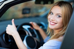 Woman in car giving thumbs up